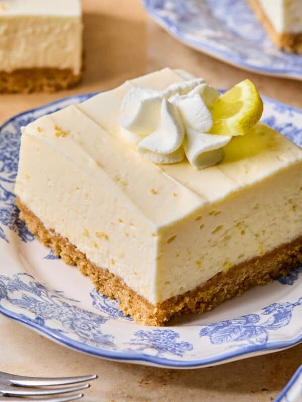 Piece of lemon cheesecake bar on plate.