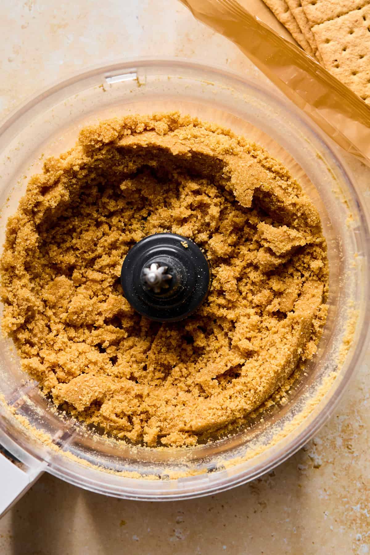 Graham cracker crust mixture in food processor.