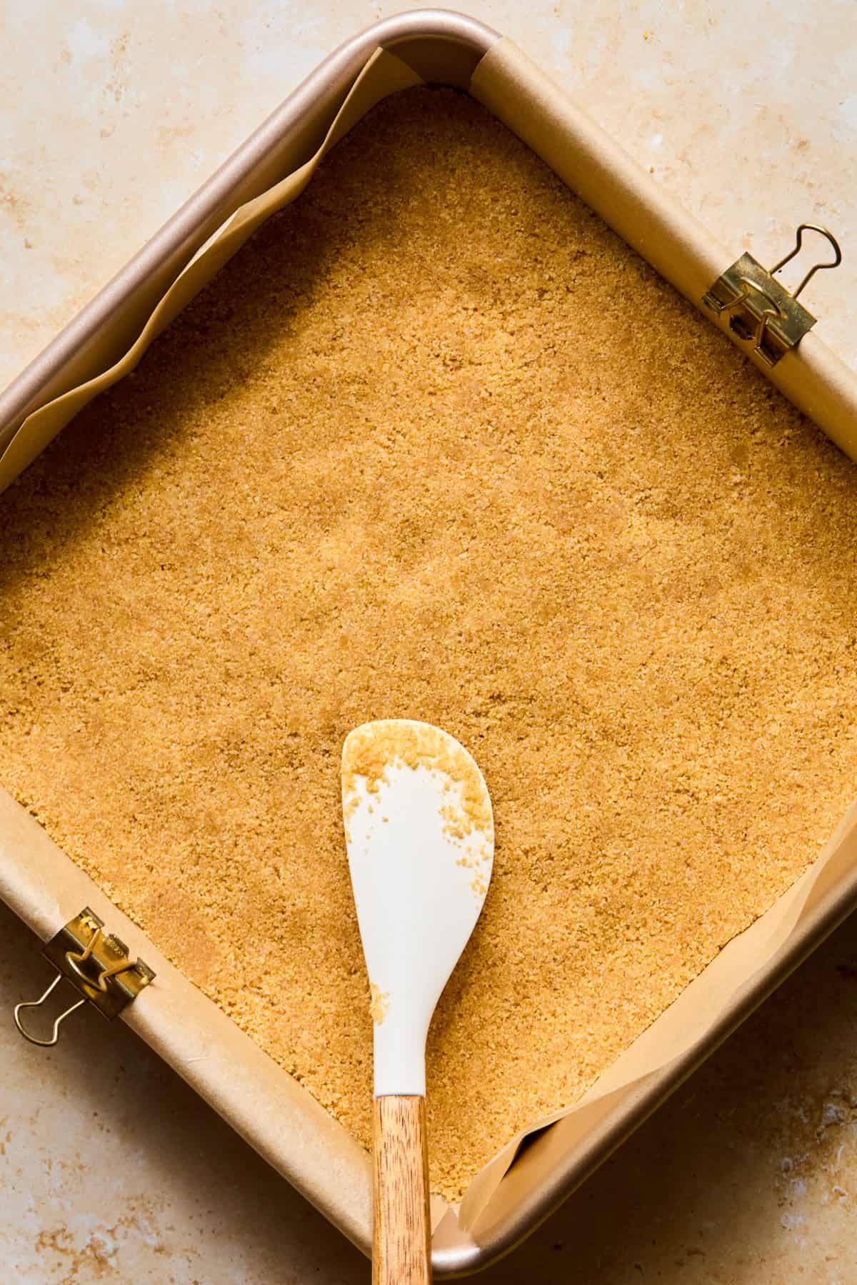 Graham crust in pan with parchment paper.