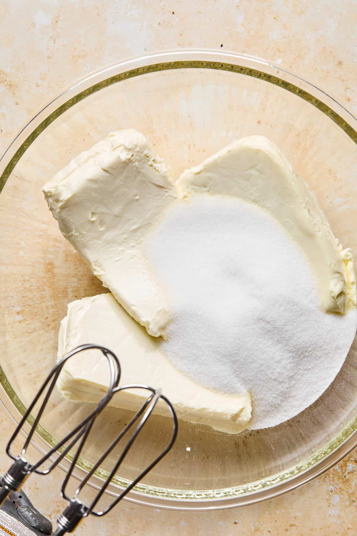 Cream cheese can sugar in glass bowl.