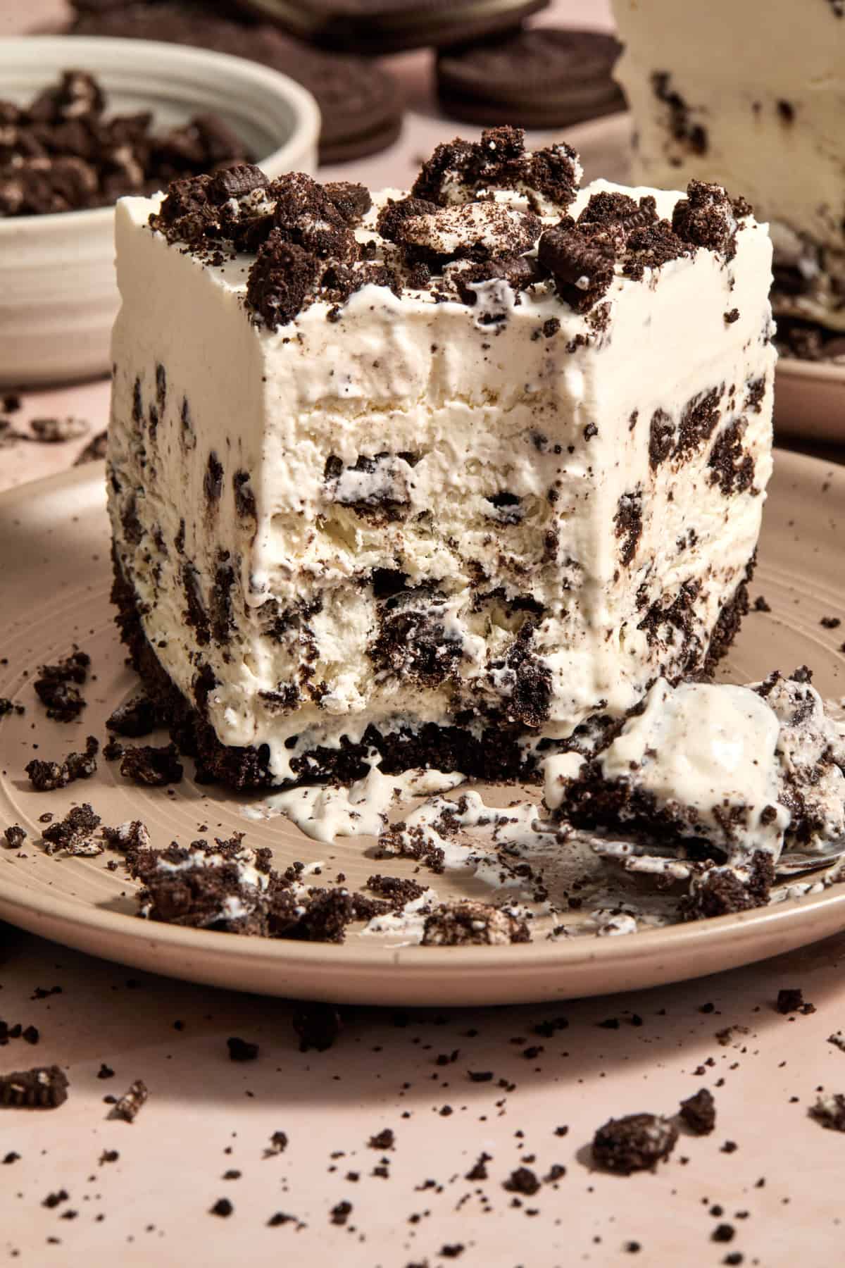 Frozen oreo ice cream pie on plate with forkful taken out.