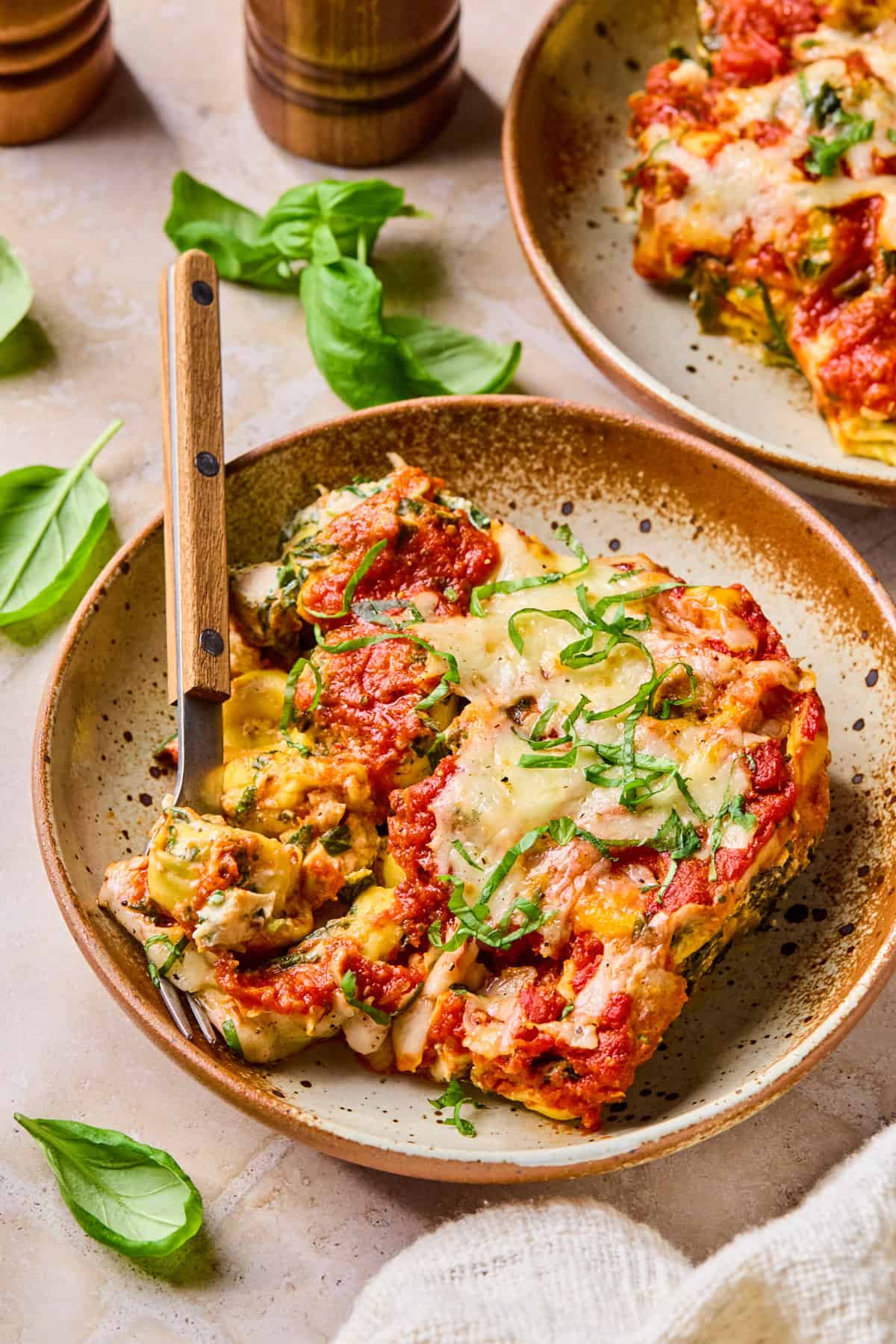 Cheesy tortellini pasta bake on plate with fork.