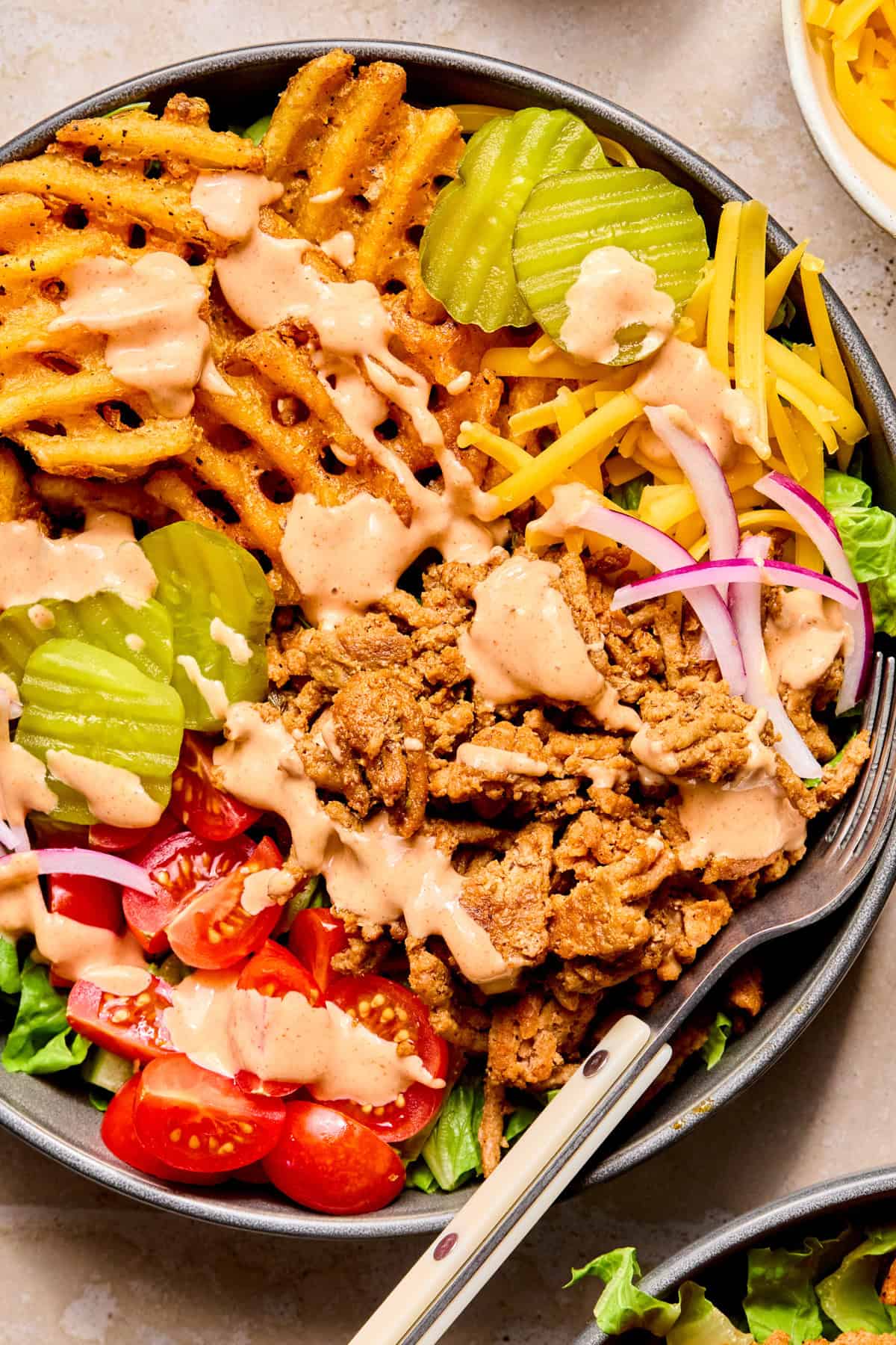 Turkey burger bowls with waffle fries, pickles, cheese and sauce.