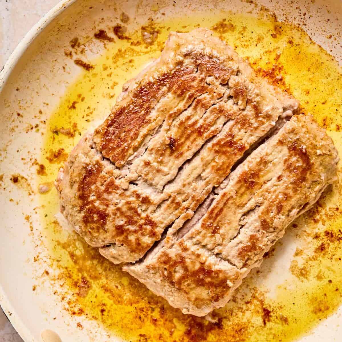 Flipped browned ground turkey in pan.