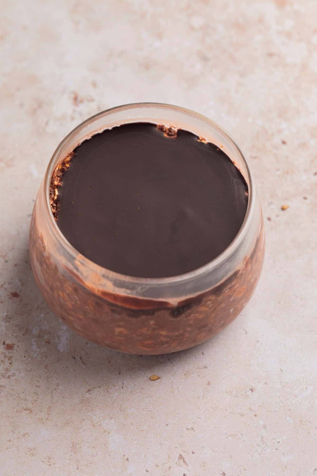 Magic shell coated chocolate overnight oatmeal in jar.