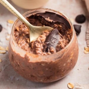 Chocolate overnight oats in jar with spoon.