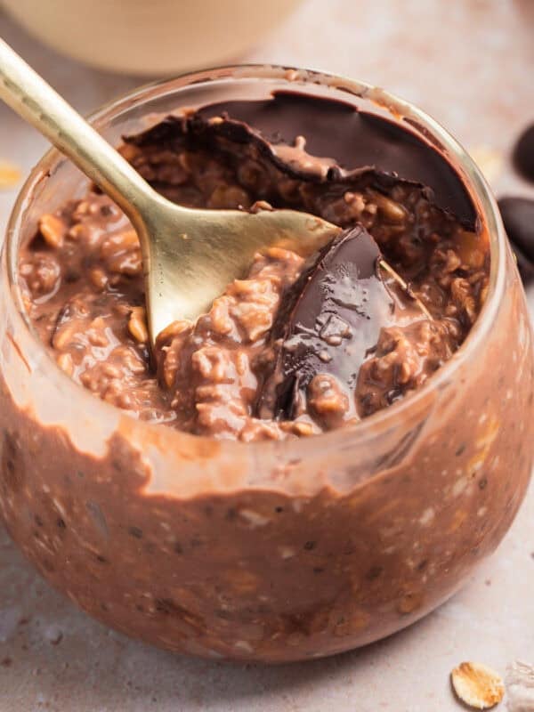 Chocolate overnight oats in jar with spoon.