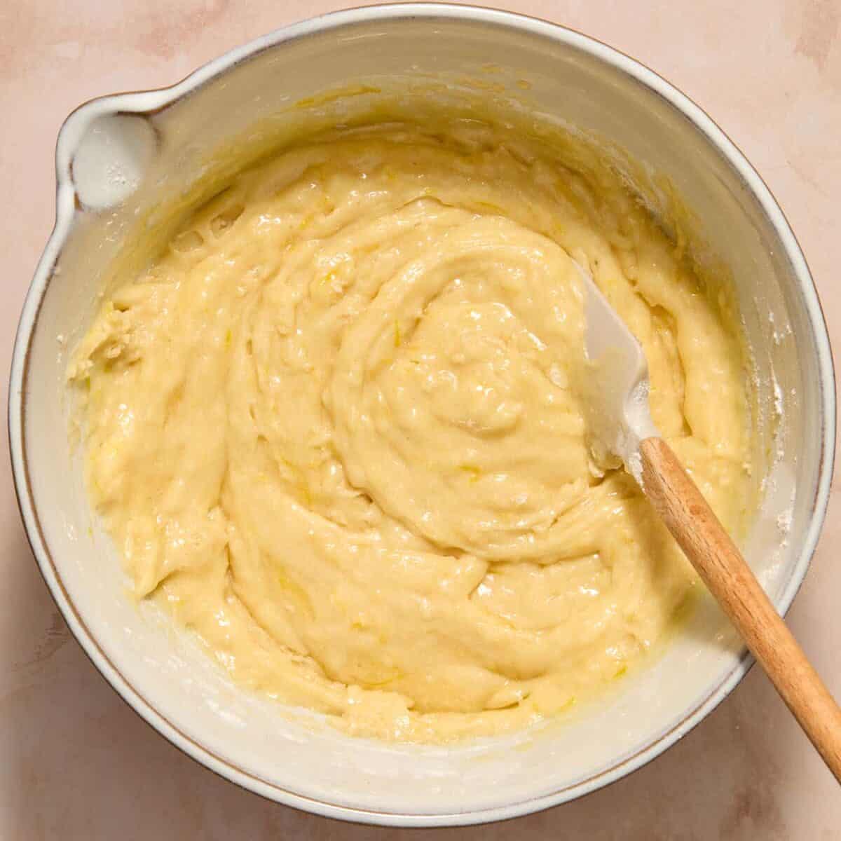 Dry ingredients combined with wet ingredients for lemon zucchini bread recipe.