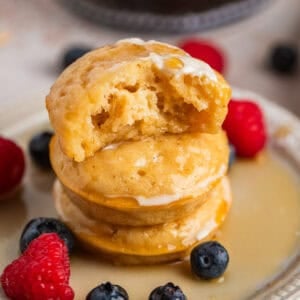 Stack of pancake bites with bite taken out of top piece.