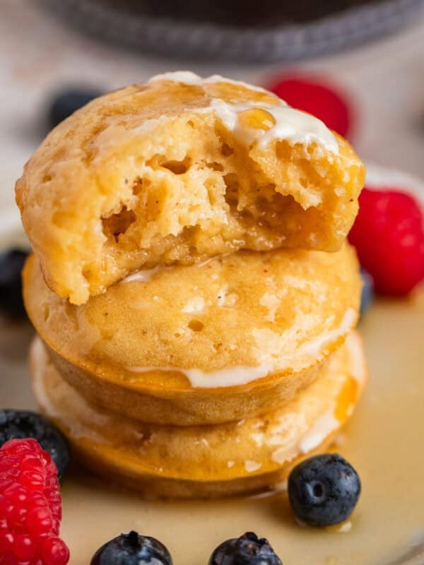 Stack of pancake bites with bite taken out of top piece.
