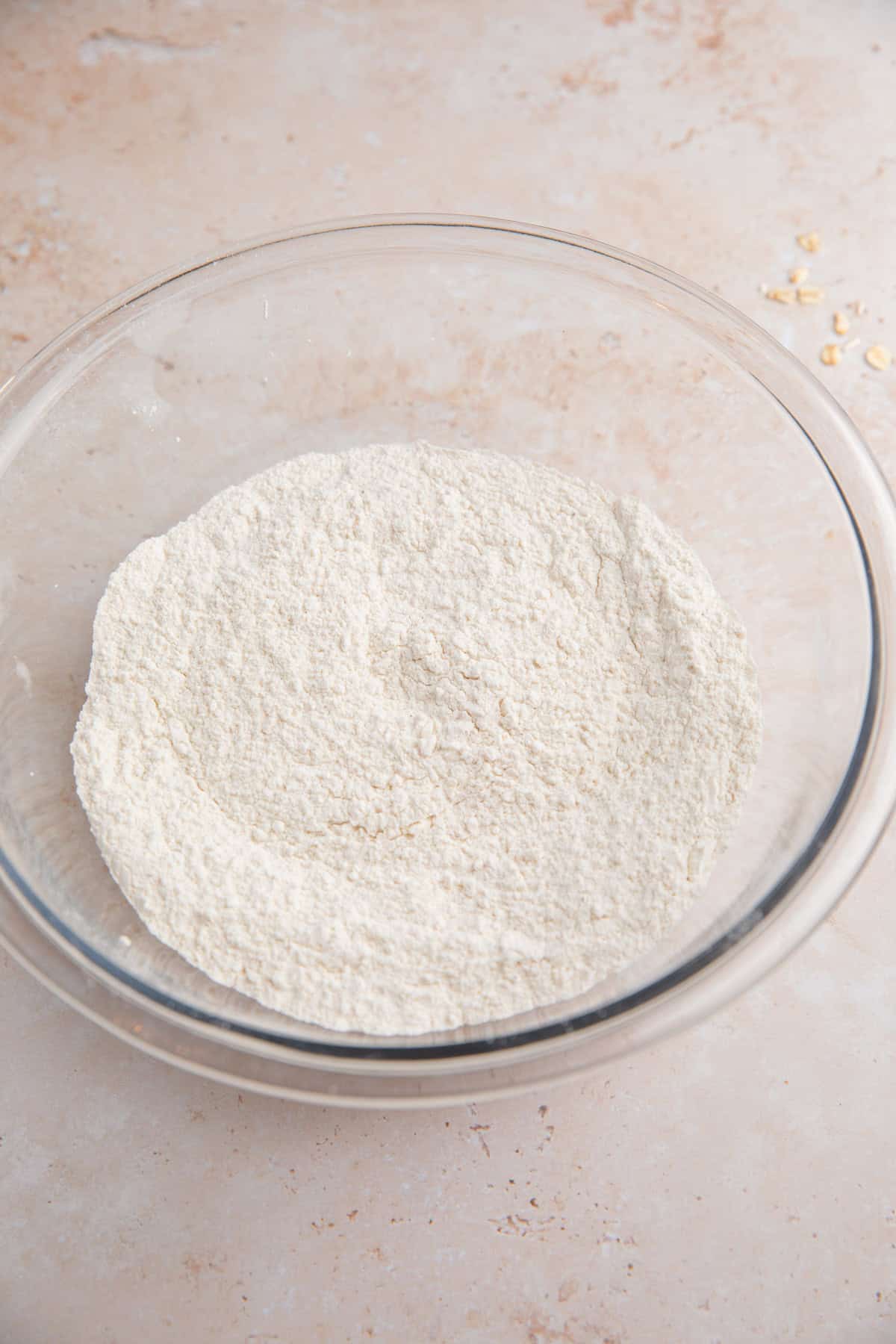 Dry ingredients mixed in glass bowl.