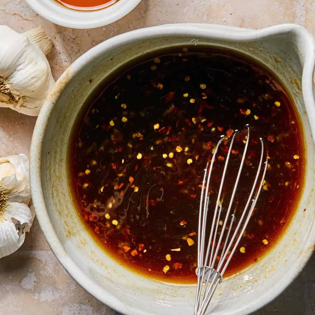 Honey sriracha sauce whisked together in mixing bowl.