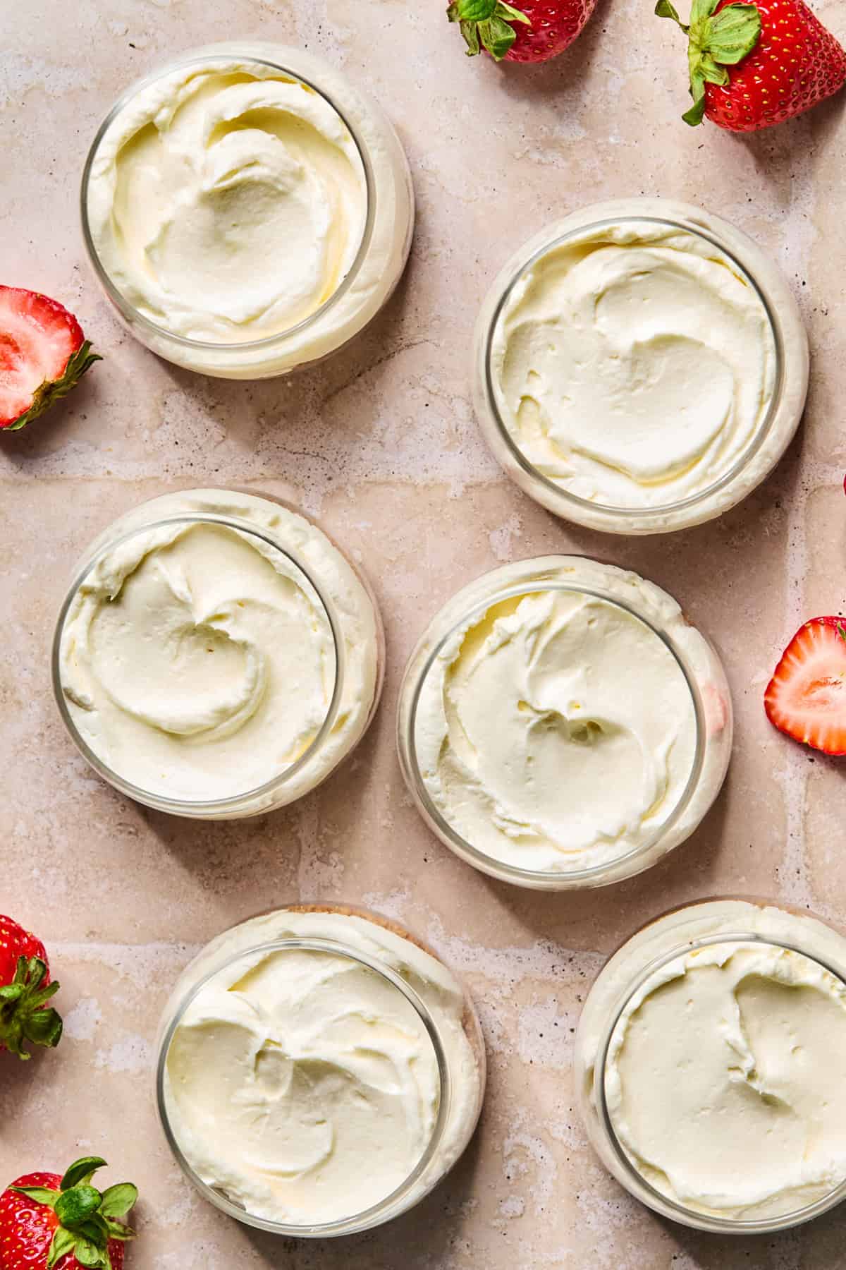 Cheesecake mixture added to dessert cups over graham cracker crust.