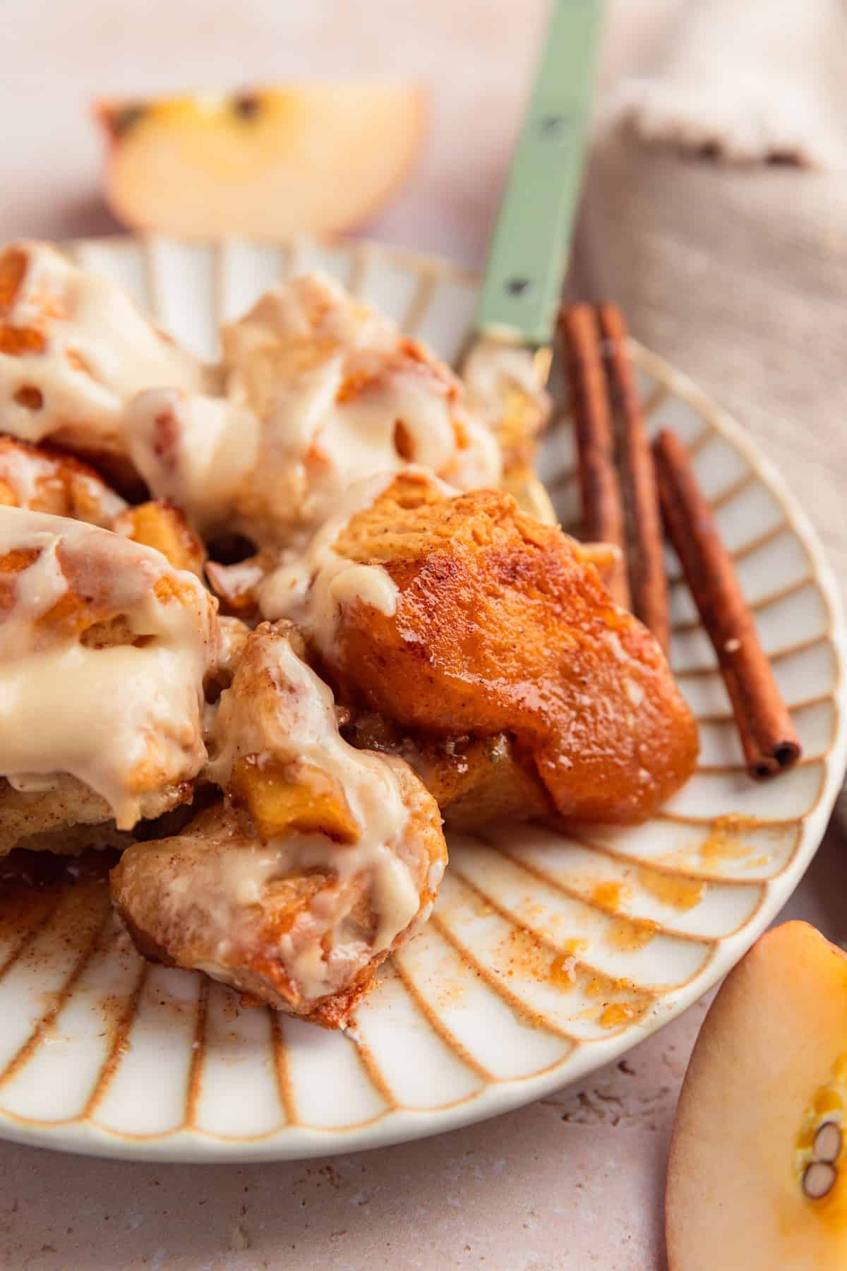 Plate with gooey apple cinnamon biscuit bake with fork.