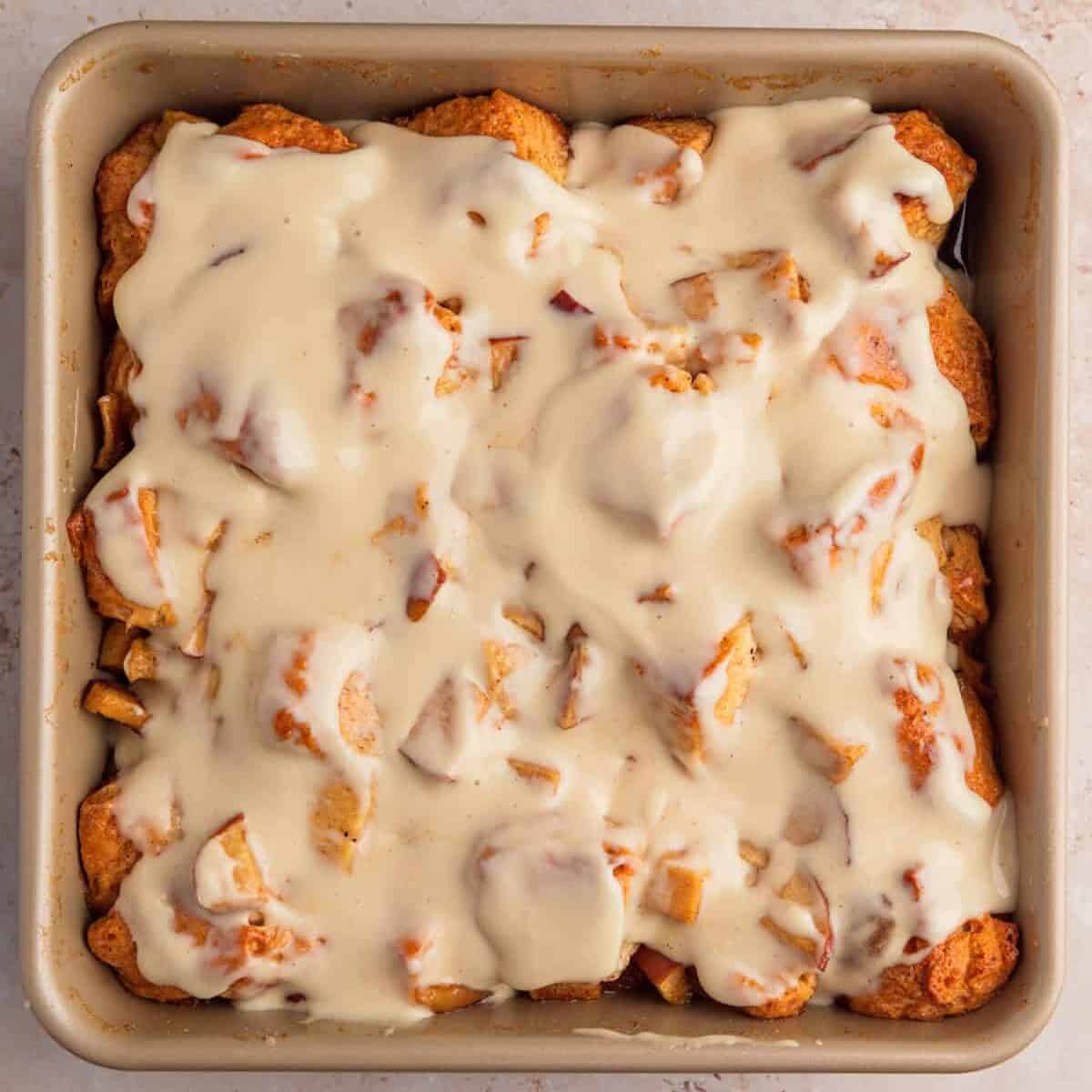Apple pie biscuit bake in pan with icing.