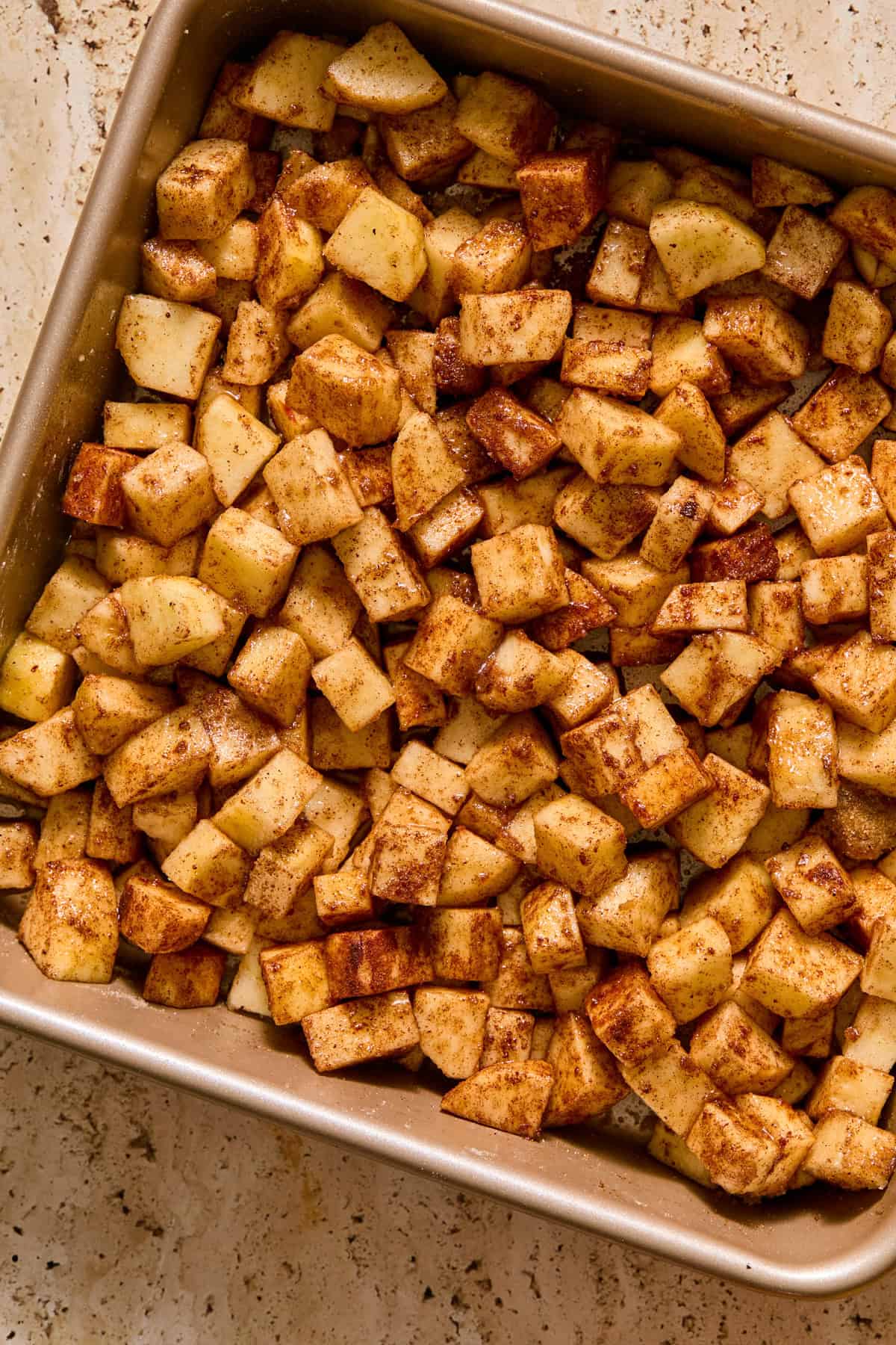 Cinnamon apples in square baking pan.