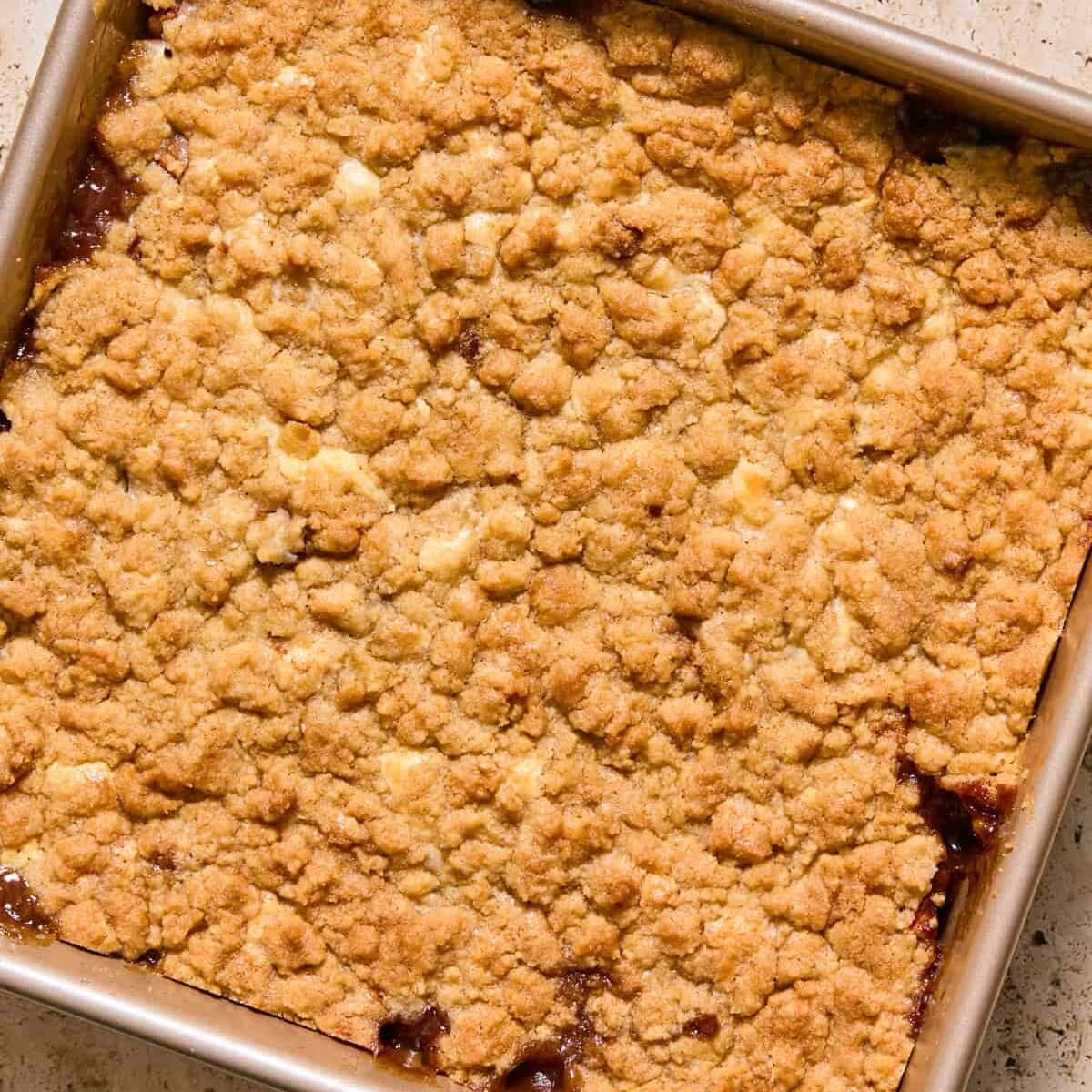 Apple cinnamon cream cheese cobbler baked in pan.