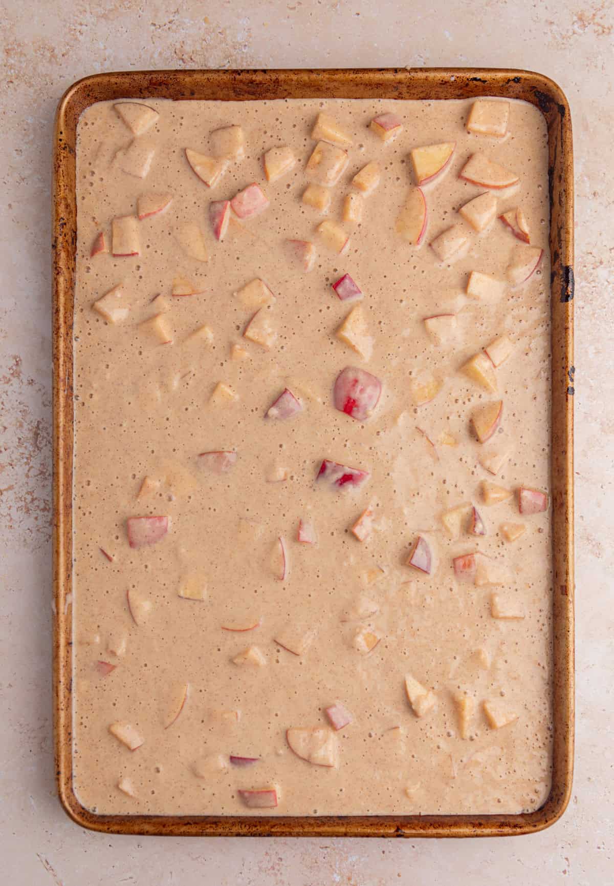 Sheet pan apple protein pancake batter on sheet pan before baking.