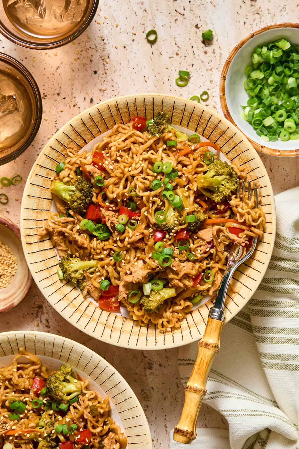 Ramen chicken and veggies in bowl with fork.