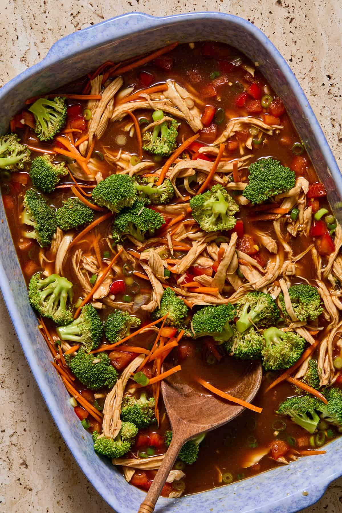 Vegetables and chicken stirred into sauce for ramen bake.