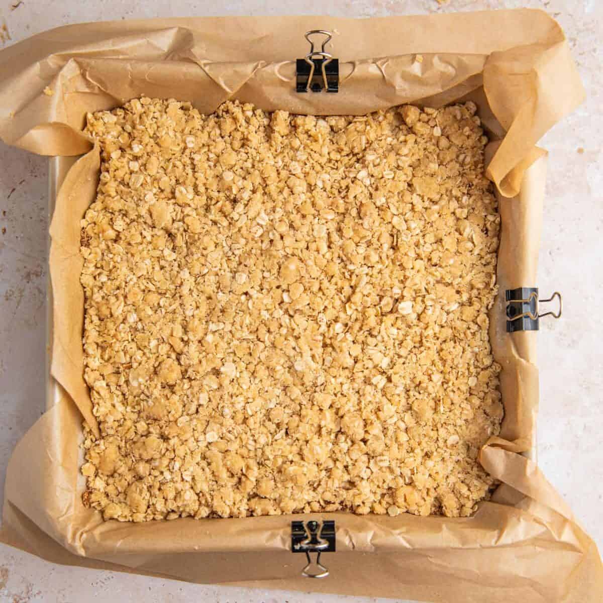Crumble topped cinnamon brown sugar bars in pan before baking.