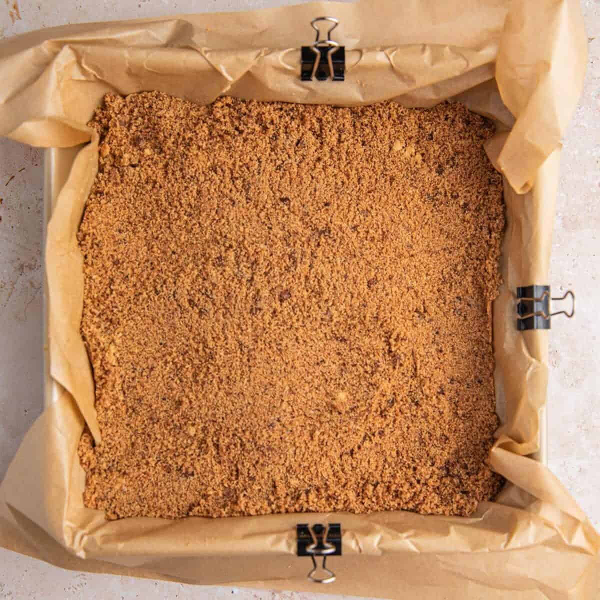 Cinnamon brown sugar mixture in pan lined with parchment.