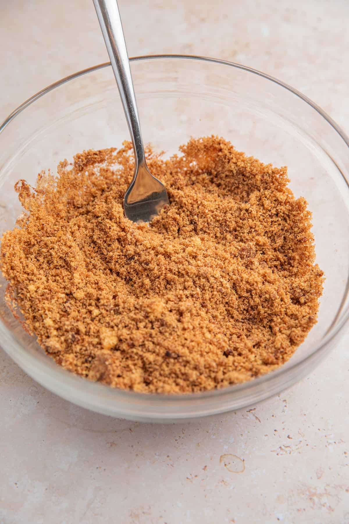 Brown sugar cinnamon mixture in bowl with fork.