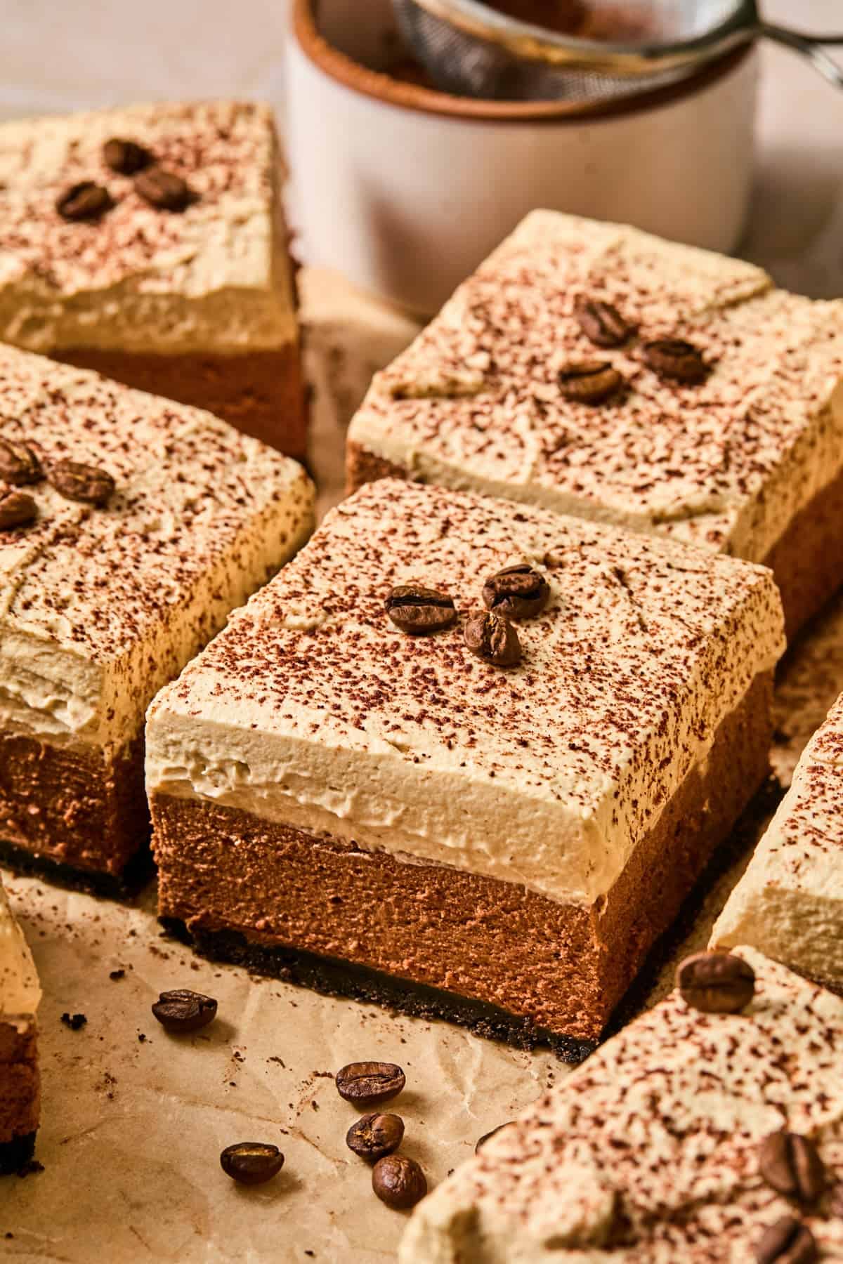Espresso martini bars on parchment topped with espresso beans.