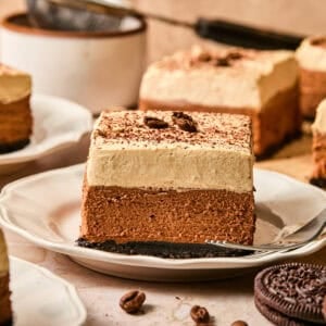 Plate with layered espresso martini bars topped with whipped cream.