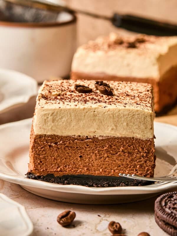 Plate with layered espresso martini bars topped with whipped cream.