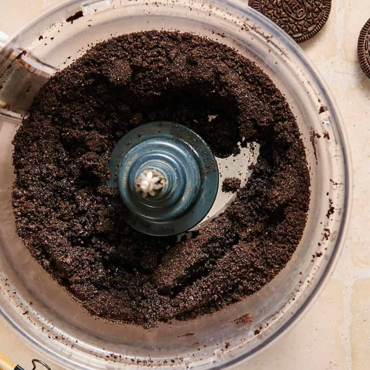 Oreo crust in food processor before transferring to pan.