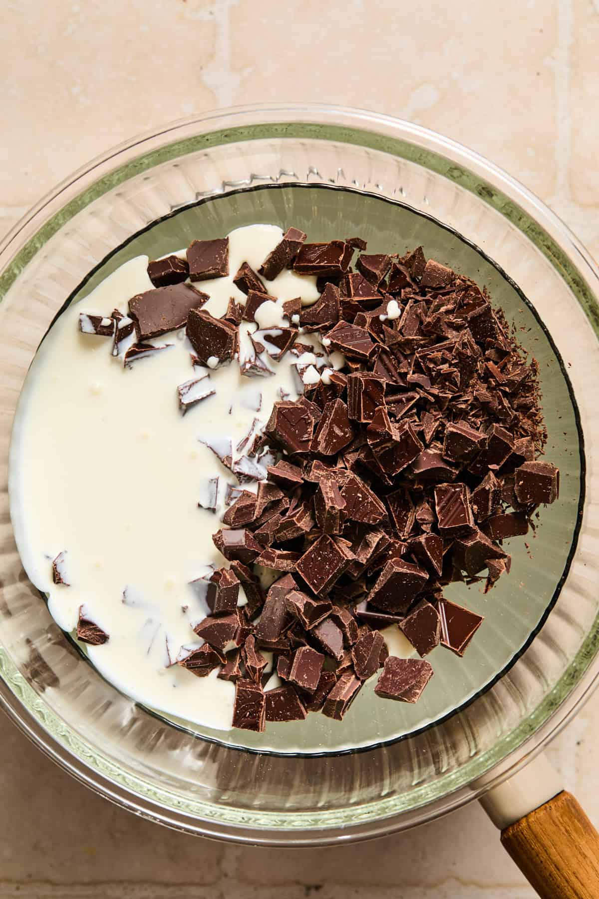 Chopped chocolate and cream in double boiler set up before melting.