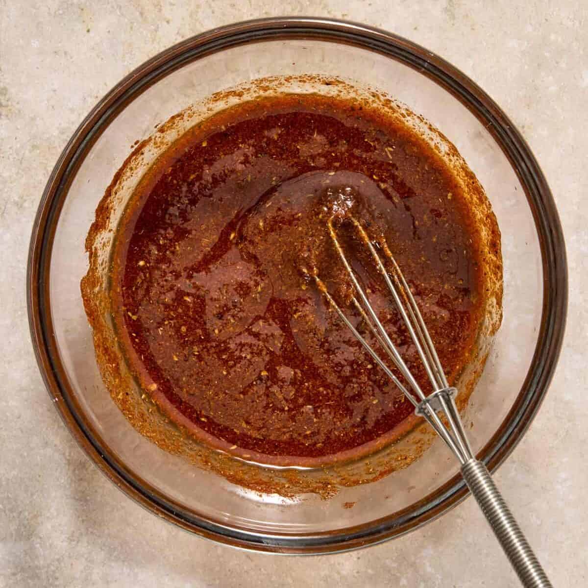 Fish taco marinade in bowl with whisk.