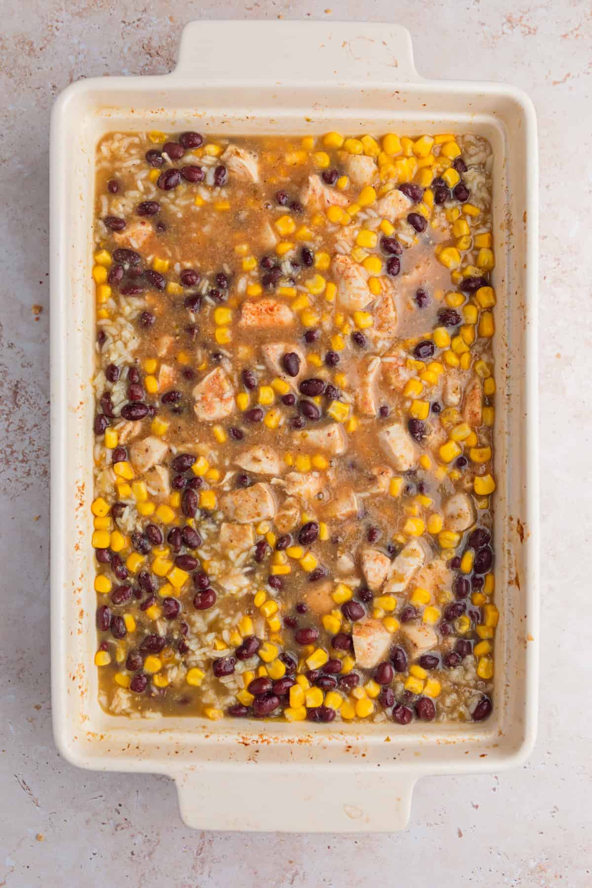 Baked salsa verde chicken with beans and corn.