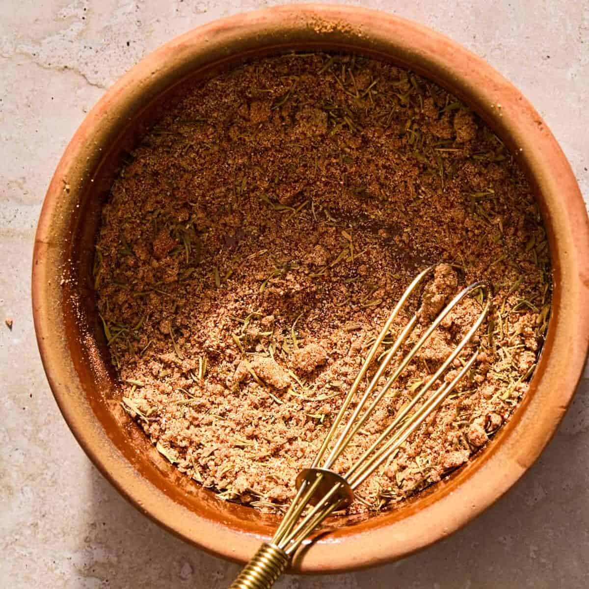 Pork roast rub in bowl with whisk.