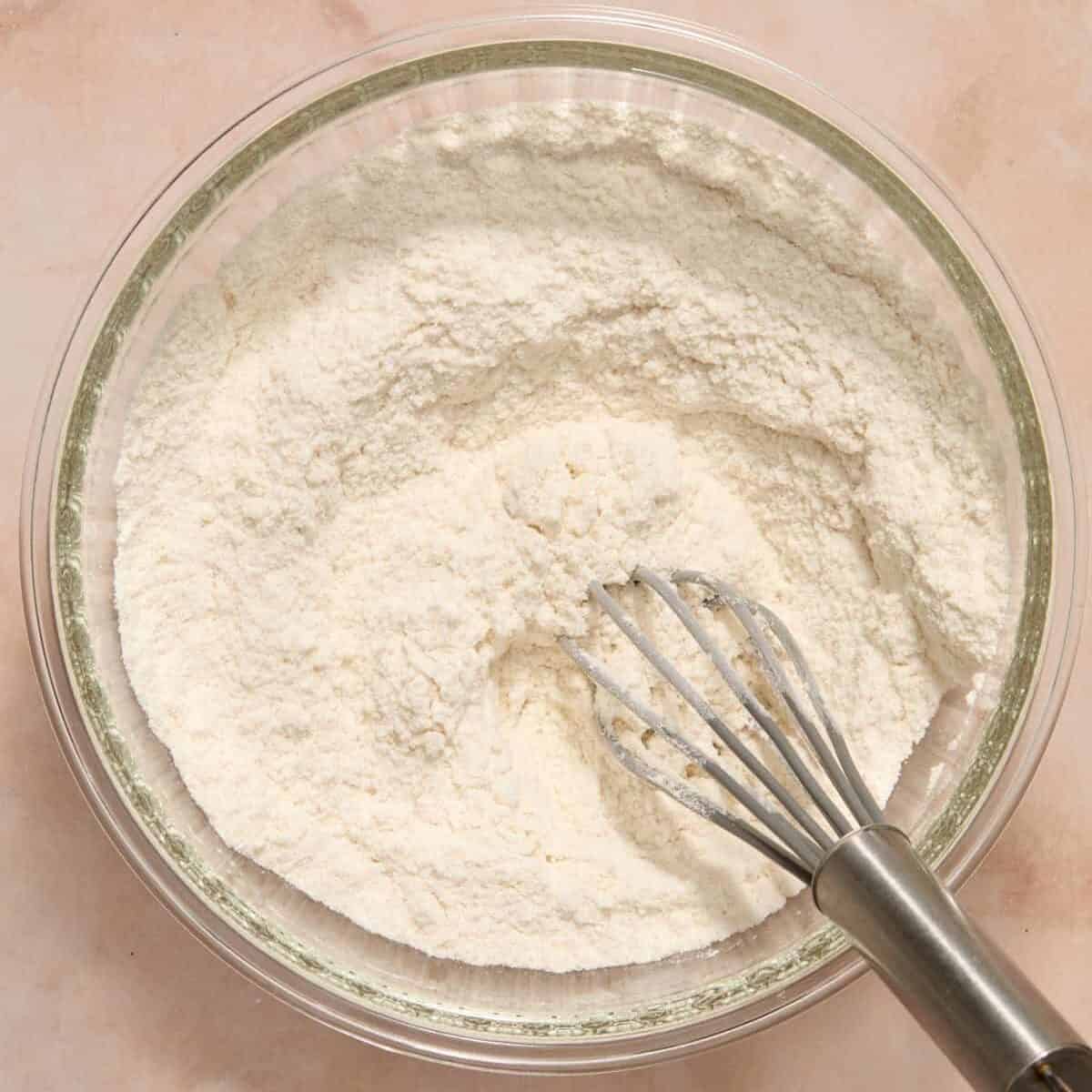 Dry ingredients in bowl with whisk.
