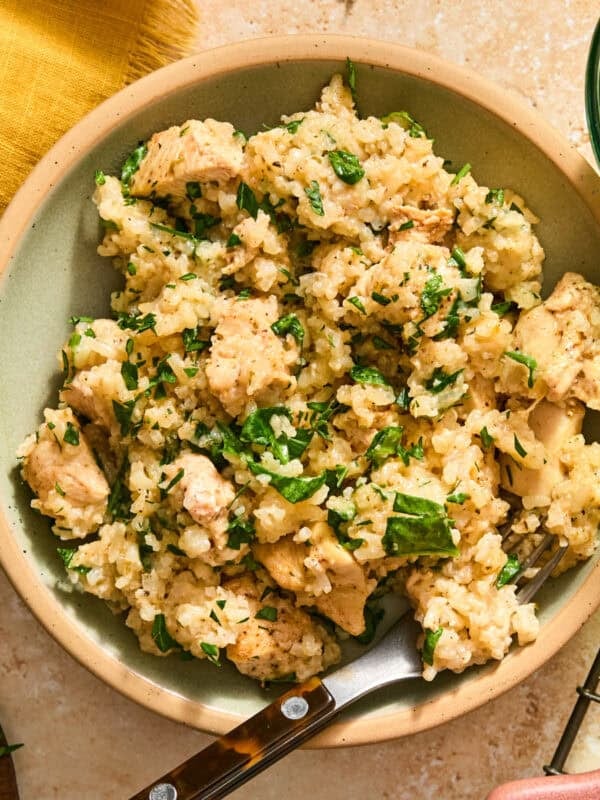 Butter herb chicken and rice served in bowl with fork.
