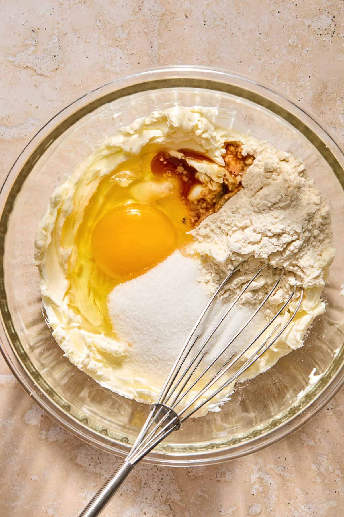 Cream cheese with egg, cinnamon and sugar added to bowl with it.