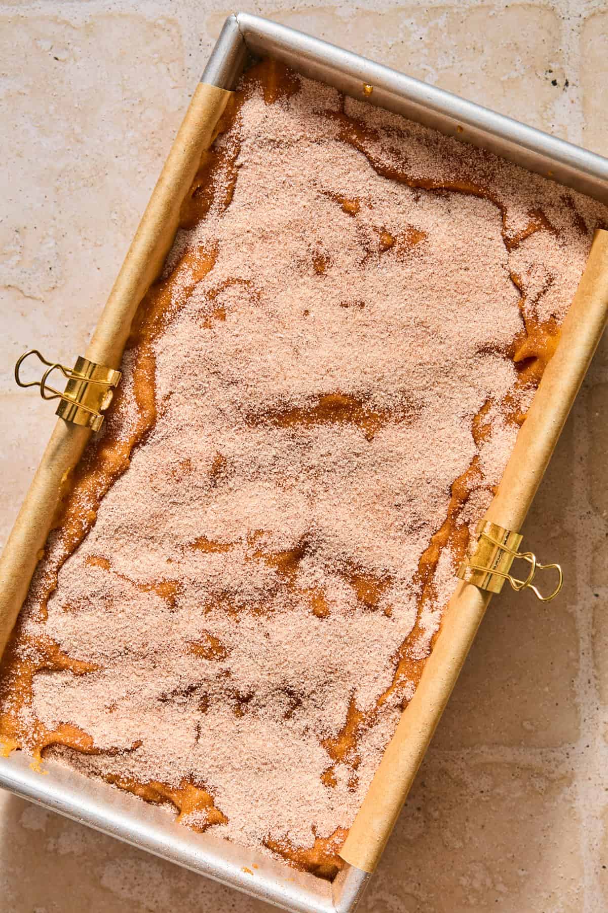 Cinnamon and cream cheese swirl pumpkin bread batter prepped in pan before baking.