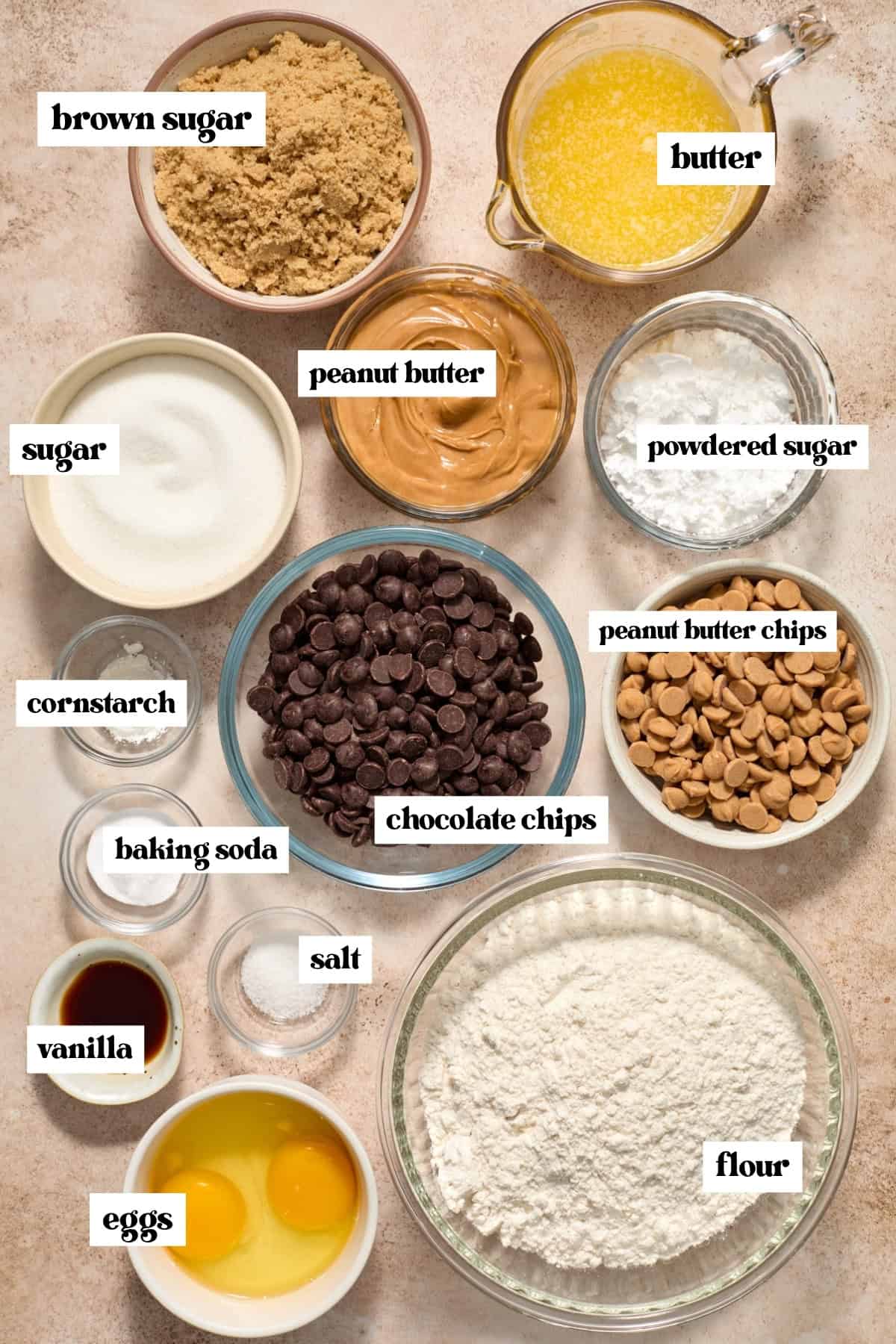 Brown sugar, flour, eggs and other labeled ingredients on surface.