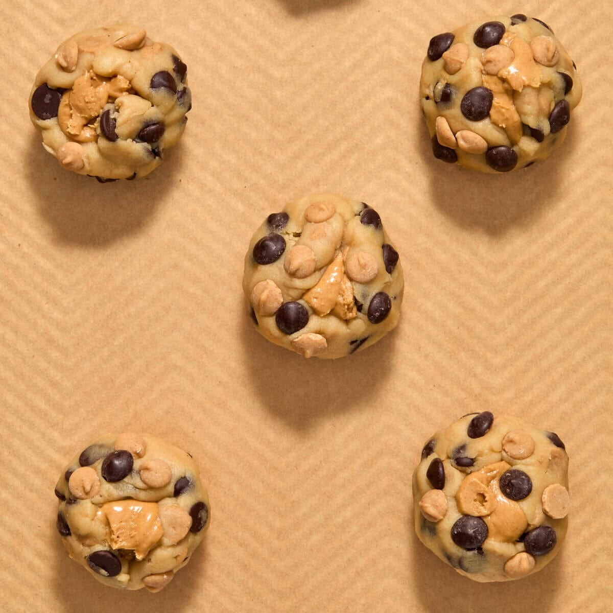 Peanut butter stuffed cookie dough on pan.