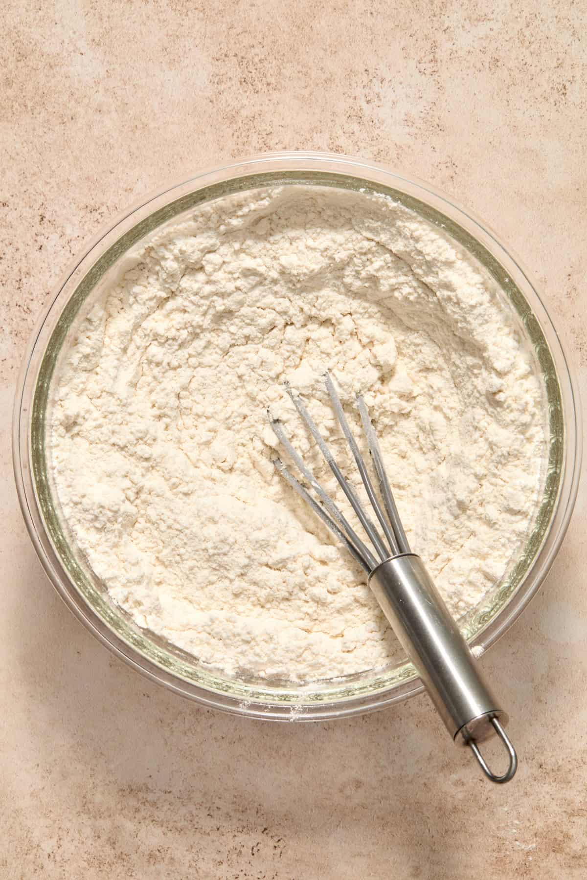 Dry ingredients combined in bowl with whisk.