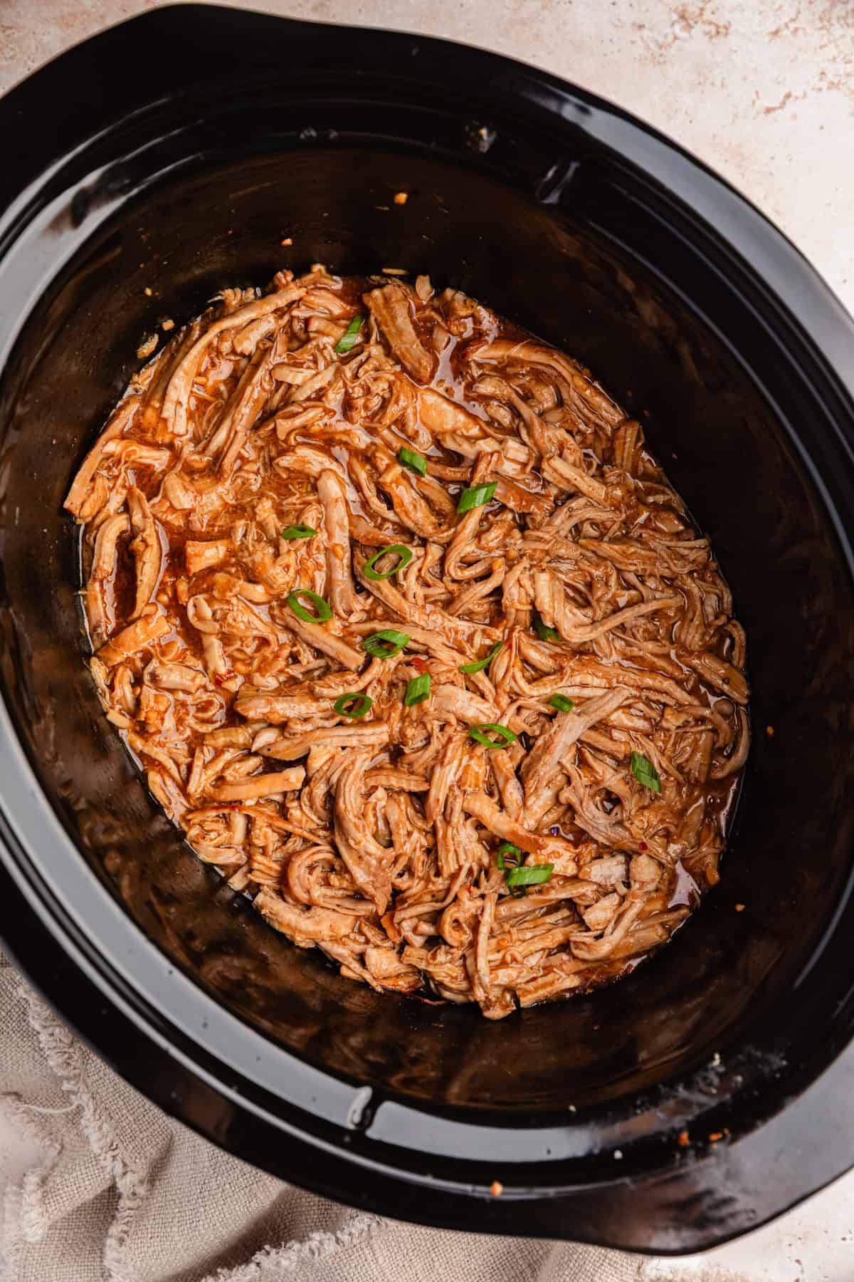 Pulled honey garlic pork tenderloin in crockpot.