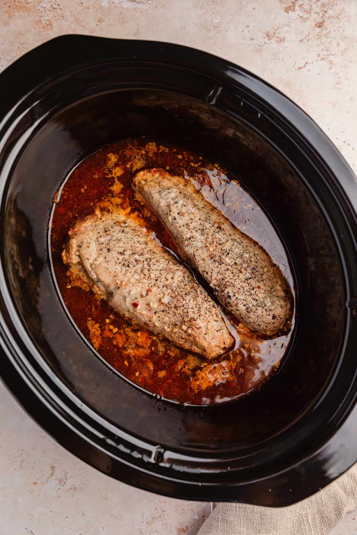 Cooked pork tenderloin in slow cooker.