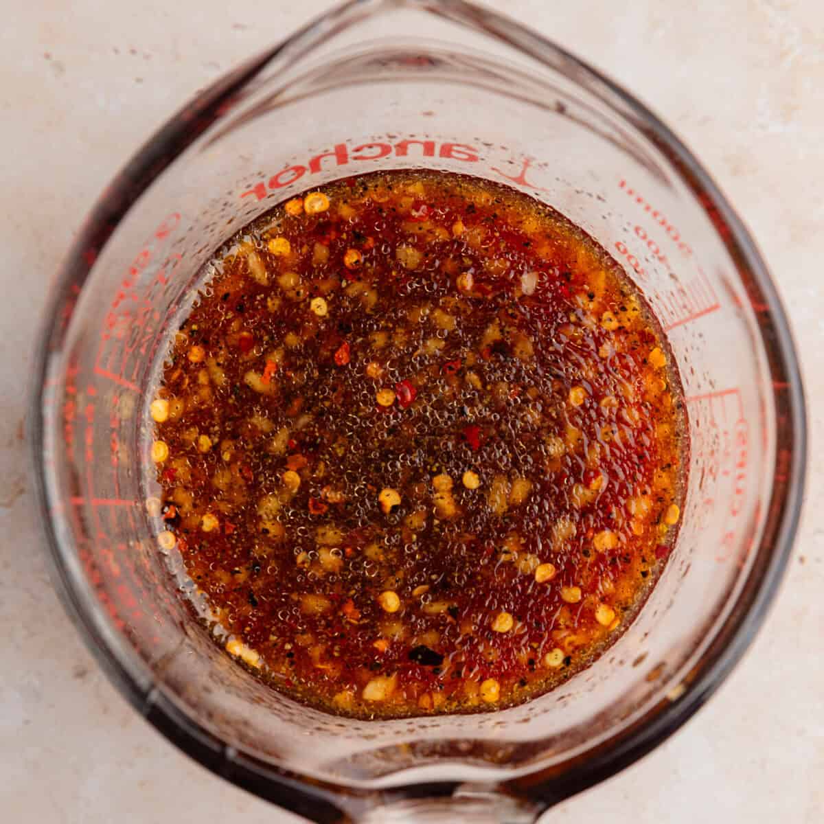 Honey garlic sauce in measuring cup.