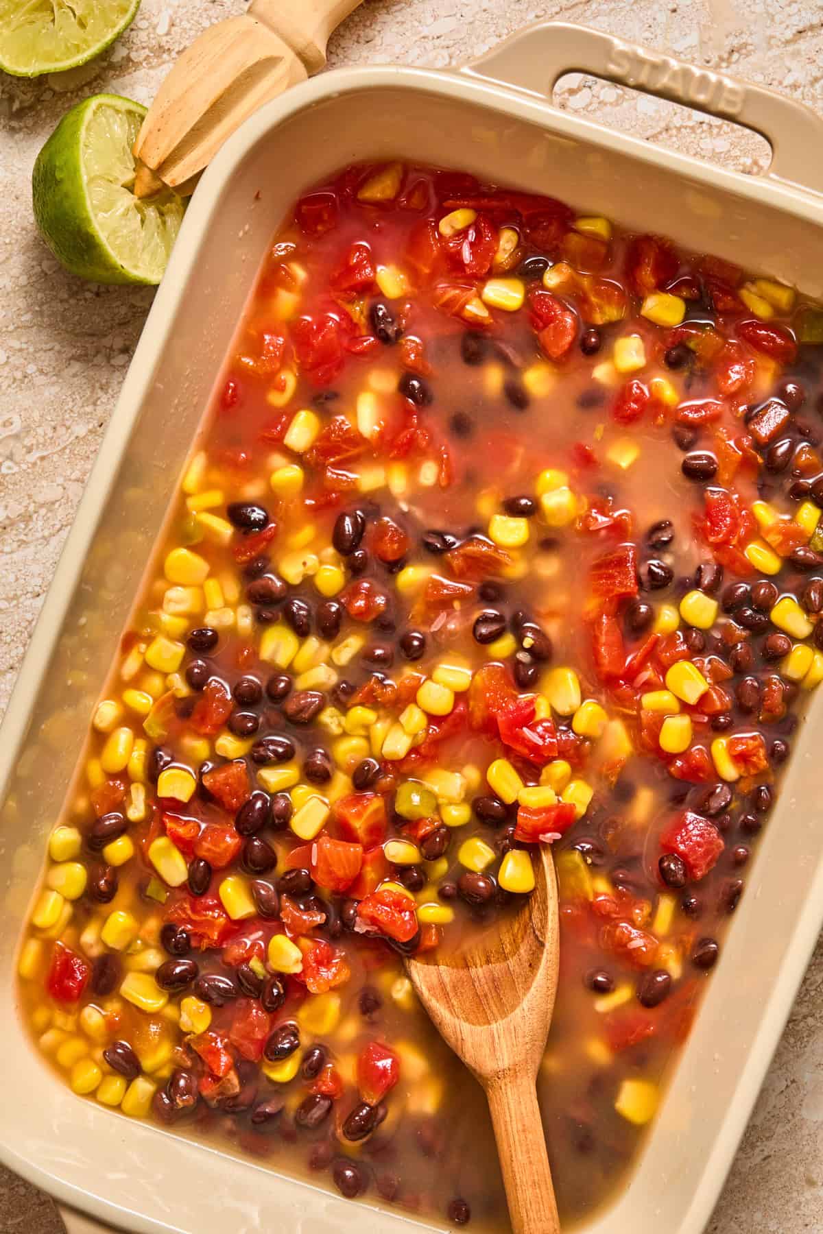 Beans, rice, broth, and other ingredients in pan.