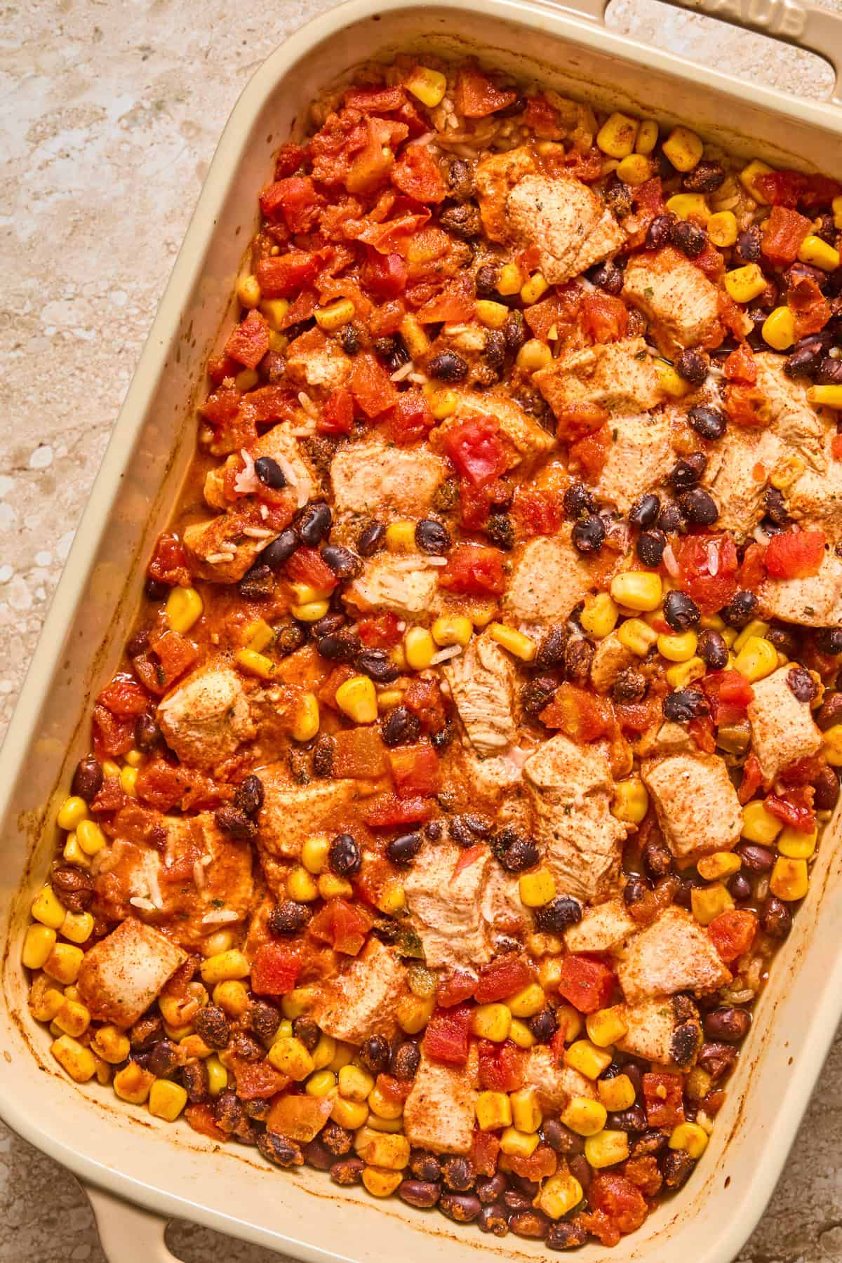 Baked chicken and rice taco casserole in pan.