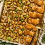 Baking pan with chicken and vegetables cooked.