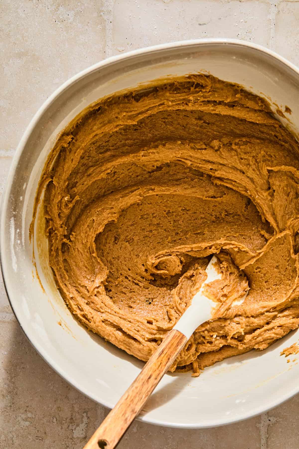 Brown sugar maple cookie dough in bowl with spatula.