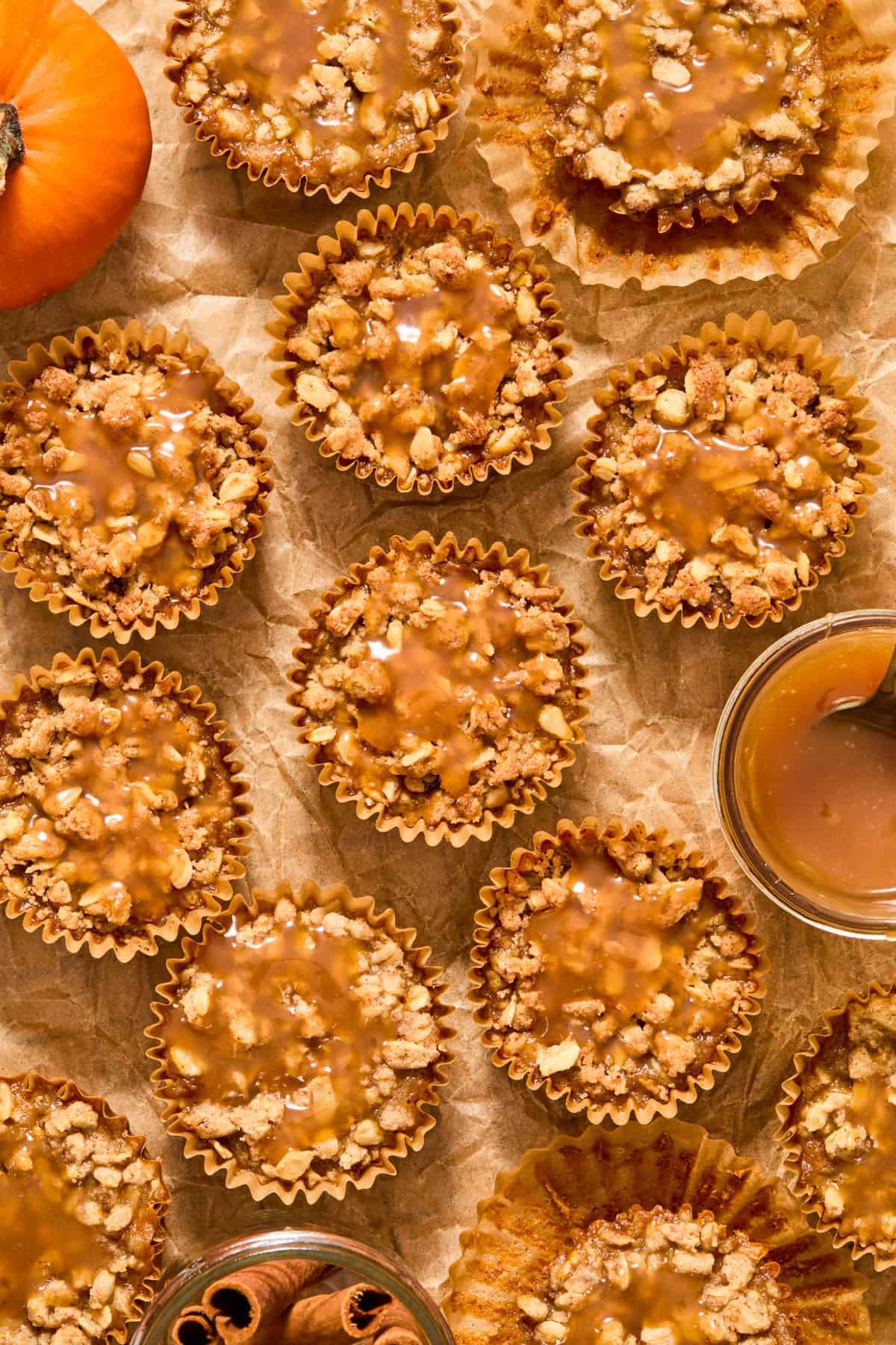 Parchment paper with miniature pumpkin crisps topped with caramel.